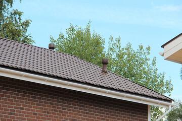 icon roof with new brown roofing tiles on residential property. banner on  roof for roofers....