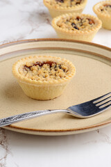 fruit crumble tart on a brown plate