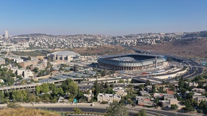 Fototapeta premium Teddy and Arena Stadium in Jerusalem Aerial view Malha neighbourhood and Arena Basketball Stadium, Begin road,South West Jerusalem, Israel 