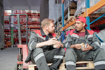 Two young intercultural workers discussing after work plans at lunch break