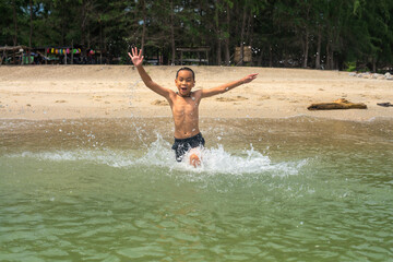 happy boy running into the sea , Summer vacation concept.