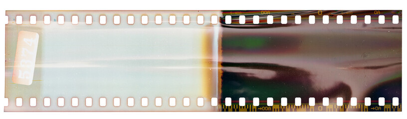 Start or beginning of 35mm negative film strip, first frames on white background, real scan of film material with shiny bright scanning light interferences.