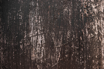 Obraz premium Dark texture of an old cracked paint on the door