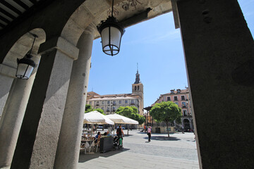 Segovia Plaza Mayor viewed through columns.