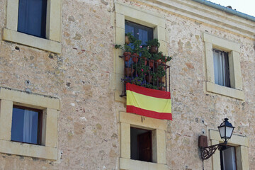 Fototapeta na wymiar House with spanish flag in medieval city of Segovia, Spain.