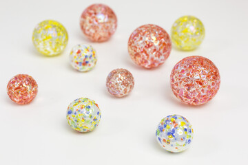 group of glass marbles with colorful sprinkles