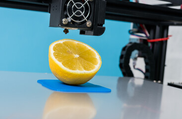 Ripe slice of yellow lemon citrus fruit . 3d printer of the device during the processe