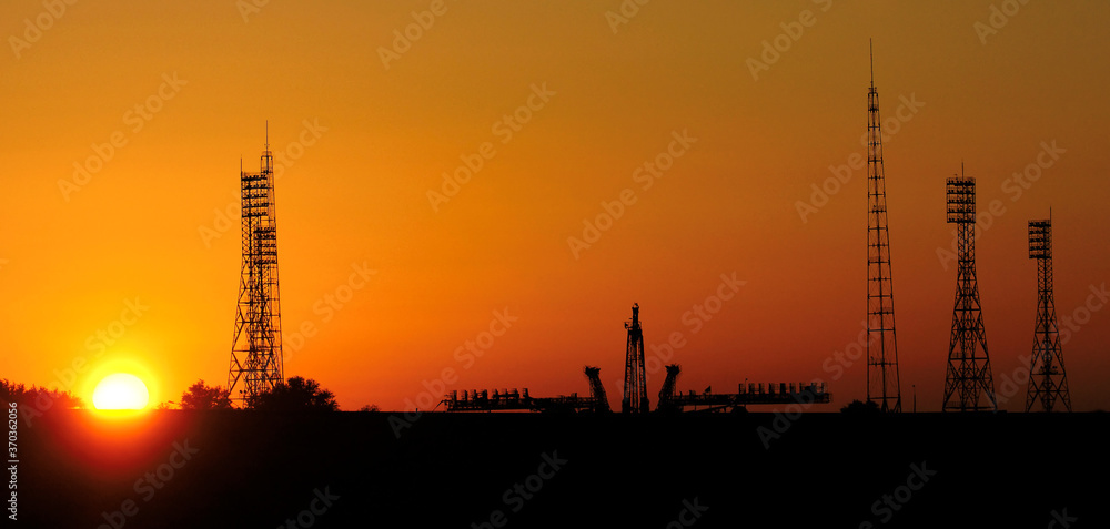 Wall mural pre-launch of spaceship in the spaceport. silhouette of space shuttle at dusk. mixed media