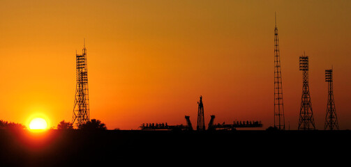 Pre-launch of Spaceship in the spaceport. Silhouette of space shuttle at dusk. Mixed media