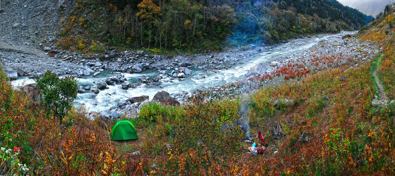 river side camping in autumn forest