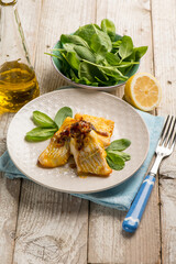 cod baked with onions and fresh spinach salad