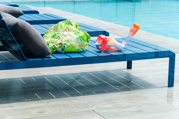 Swimming pool with chaise loungers background