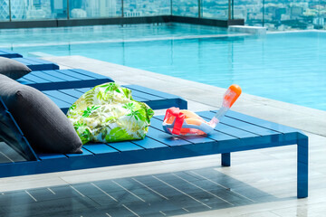 Swimming pool with chaise loungers background