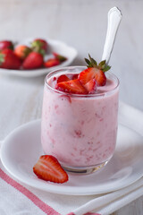 Yogurt with fresh strawberry in glass