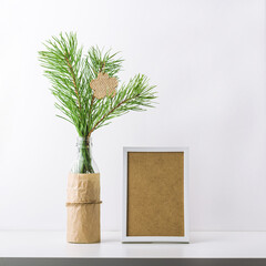 New year composition with Christmas tree branch in glass bottle and