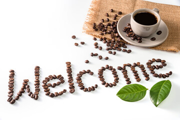 Coffee cup and text Welcome made of coffee beans, isolated on white.