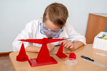 the little specialist performs laboratory work, uses the scales
