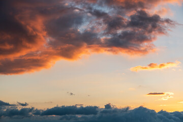Beautiful bright sunset sky. Dramatic colorful clouds after sunset. Nature, sunset clouds backgrounds.