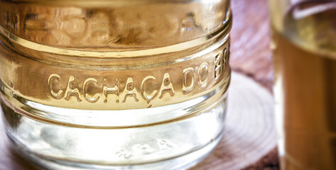 detail of cachaça bottle, international cachaça day in brazil, september 13, with rustic wood brazil, bar image, old cellar.