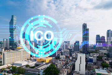 ICO icon hologram over panorama city view of Bangkok, the hub of blockchain projects in Asia. The...