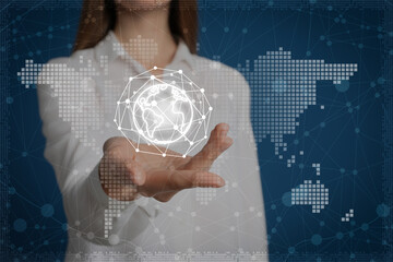 Young woman demonstrating world globe with network connection lines on blue background, closeup. Modern technology