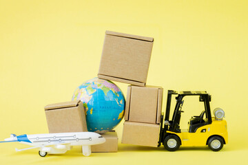 Mini forklift truck load cardboard boxes in the Airplane. Fast delivery of goods and products. Logistics, connection to hard-to-reach places. Banner, copy space