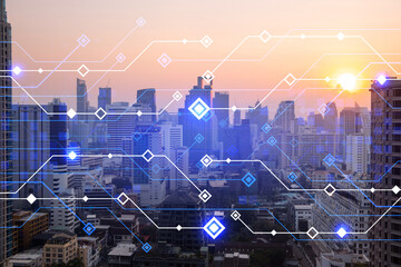 Glowing hologram of technological process, aerial panoramic cityscape of Bangkok at sunset. The...