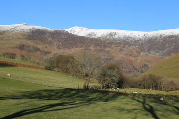 Fototapeta na wymiar Winter sunshine on a snow covered Cadair Idris in Gwynedd, Wales.
