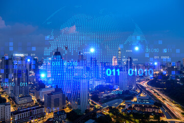 Hologram of Earth planet map on night panoramic cityscape of Kuala Lumpur, Malaysia, Asia. The...