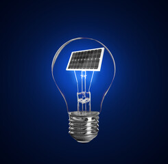 Alternative energy source. Light bulb with solar panel on blue background