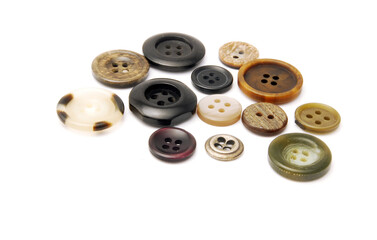A bunch of buttons of various types and sizes on a white background