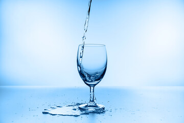 water splash collection in wine glass isolated on blue background