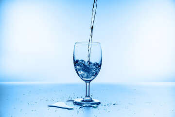 water splash collection in wine glass isolated on blue background