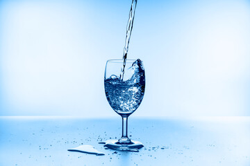 water splash collection in wine glass isolated on blue background