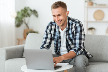 Guy listening to music online in headphones