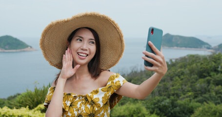 Travel woman take selfie on cellphone at countryside