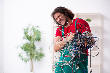 Funny young male electrician working indoors