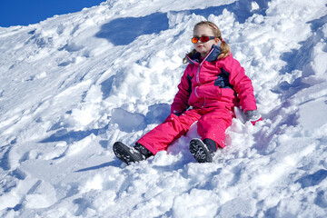 Fototapeta na wymiar Young Girl Sitting On The Snow Mountain