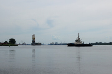 Tugboat returns to dock. An ordinary working day at a seaport.