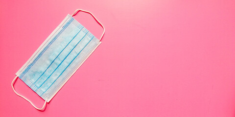 medical mask on pink background. Protection concept  in the time of coronavirus