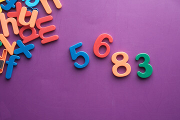 colorful plastic letters on purple background, Top view 