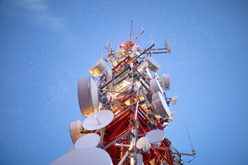 stars in night sky above radio tower