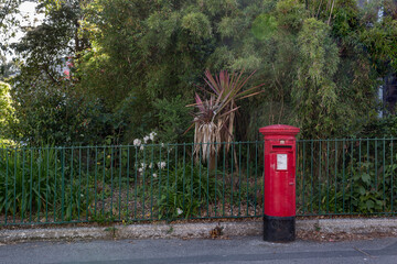 Fototapeta na wymiar Red letter box outside public park in Penzance, Cornwall UK