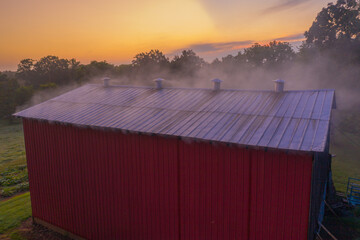 sunrise over a smoking barn