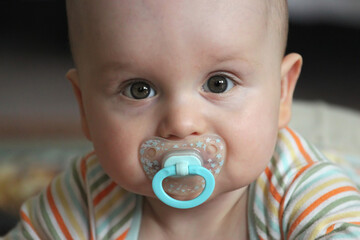 baby boy with dummy from close-up