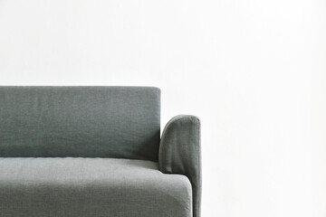 Gray fabric sofa on white wall, Minimal and simple living room interior with copyspace.