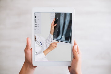 Hands holding tablet while your doctor gives you directions in a telematics consultation