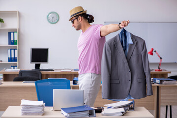 Young male employee preparing for the trip