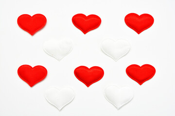 Red and white hearts on a white background