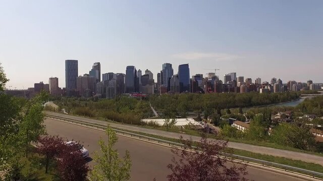 Drone Pushes Through the Treeline and Glides Towards the Skyline of Calgary, Alberta, Canada